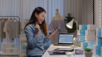 woman on the phone inside her business